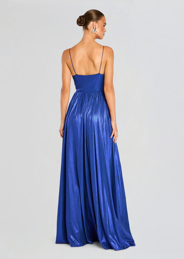 Back view of a royal blue spaghetti strap dress with a fitted bodice and flowing skirt.