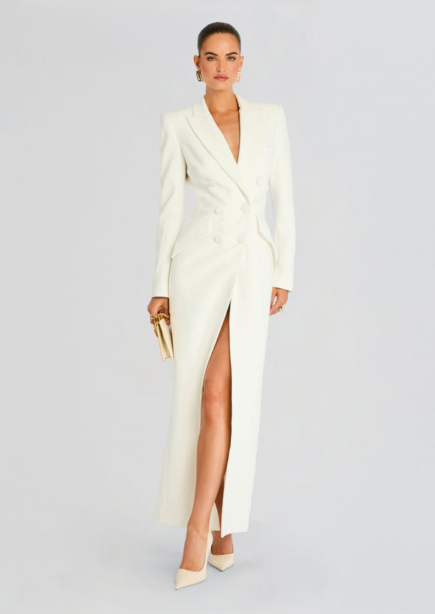 Model wearing Amberly Blazer Evening Dress in a white double-breasted blazer style gown with a front slit.
