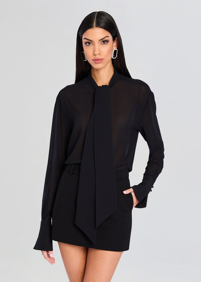 Model wearing a black sheer Neave Button Down shirt with a long necktie draped at the neckline media 1 of 5