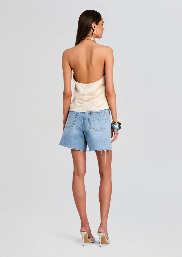 Back view of a model in Sabrina Boyfriend Short with light wash denim and frayed hem.