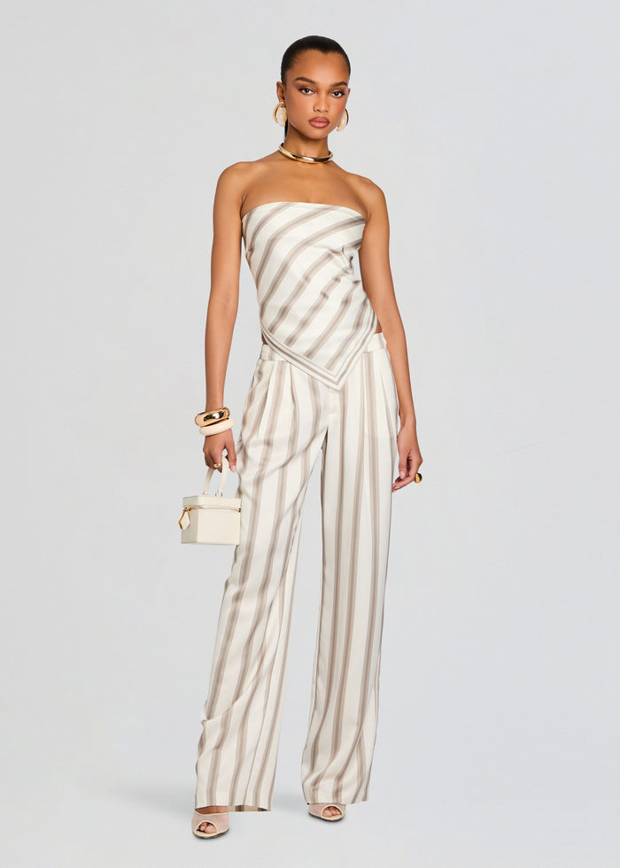 Full length model wearing a strapless satin top with a diagonal wrap and matching striped wide leg pants. media 5 of 5