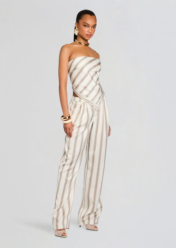 Full-length model wearing the Marlowe Satin Pant set with a striped bandeau top tied at the back.