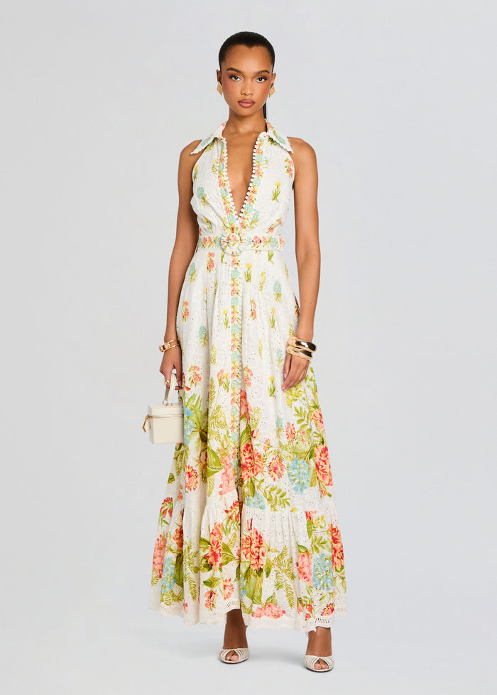 Front view of Dhun Long Shirt Dress with deep V neckline floral print belted waist and small white handbag. media 5 of 5