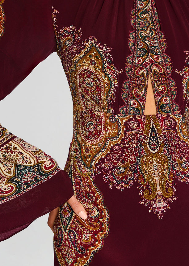 Shifa Long Dress close up of rich burgundy fabric with intricate gold and cream paisley motifs along the bodice and sleeves.
