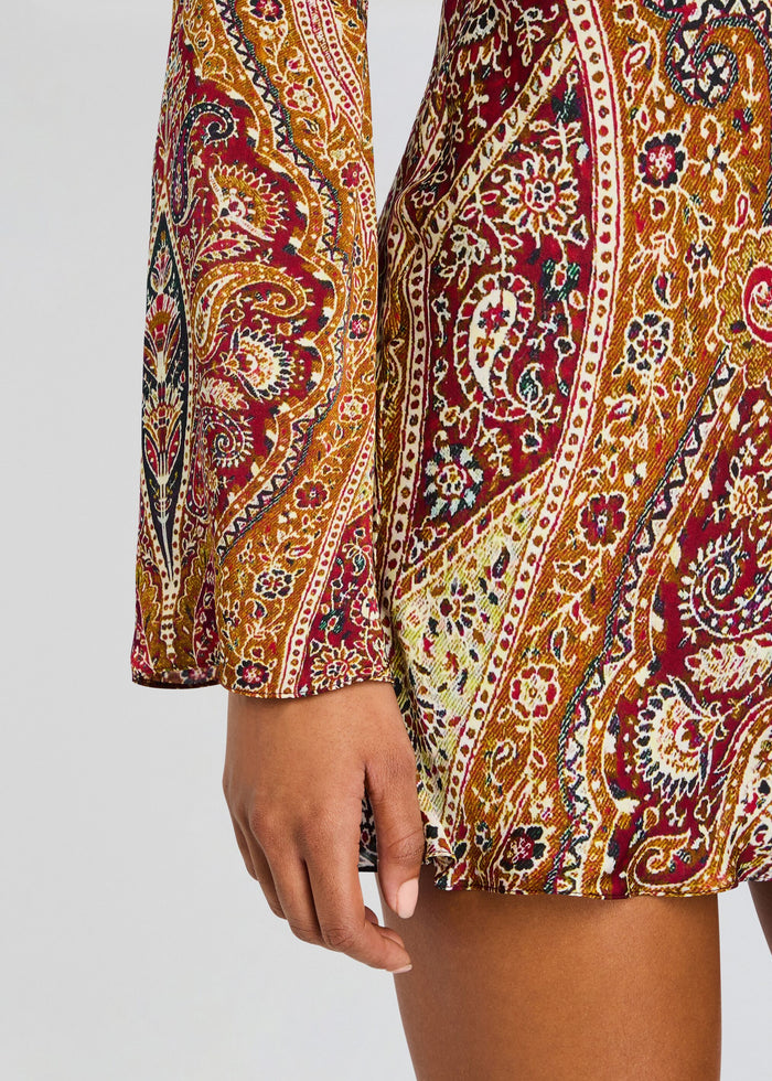 Close up of burgundy gold and white paisley pattern on the Shifa Mini Dress fabric. media 2 of 5