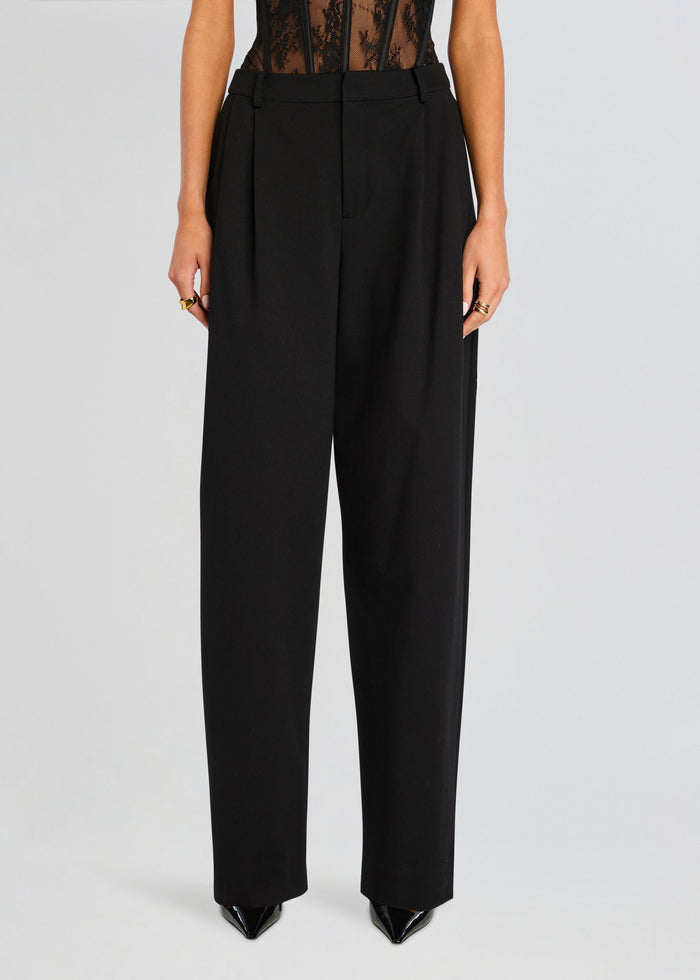 Full-length view of black Sonya Pant tailored wide-leg trousers on a model. media 1 of 5