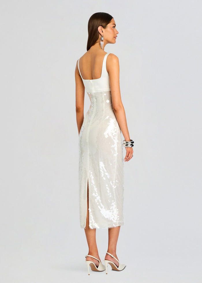 Back view of Yvaine Sequin Dress on a model showing a white top with wide straps and a sparkling sequined midi skirt media 4 of 5