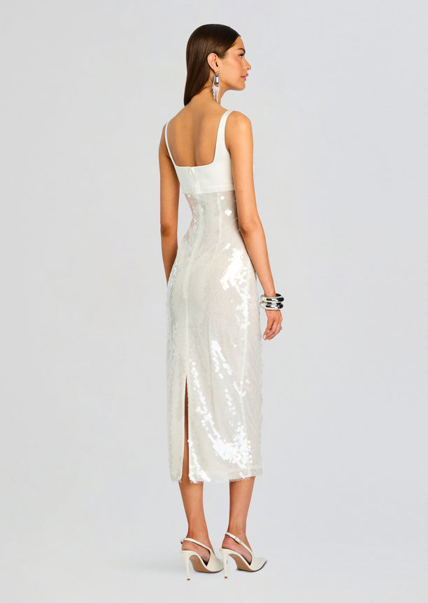 Back view of Yvaine Sequin Dress on a model showing a white top with wide straps and a sparkling sequined midi skirt