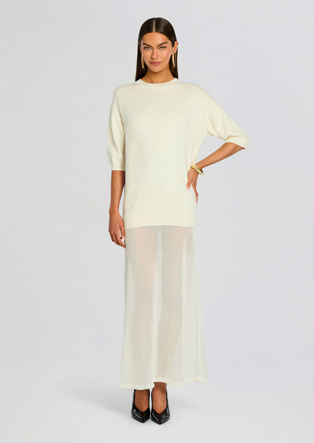 Front view of a model wearing the Arwen Knit Maxi Dress ensemble a cream knit tunic with a sheer maxi skirt