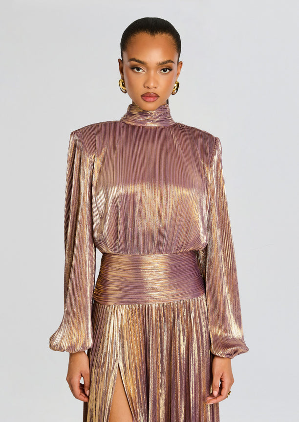 Front view of Brienne Dress in metallic rose gold pleats with a high neckline wrapped waist belt and thigh high slit