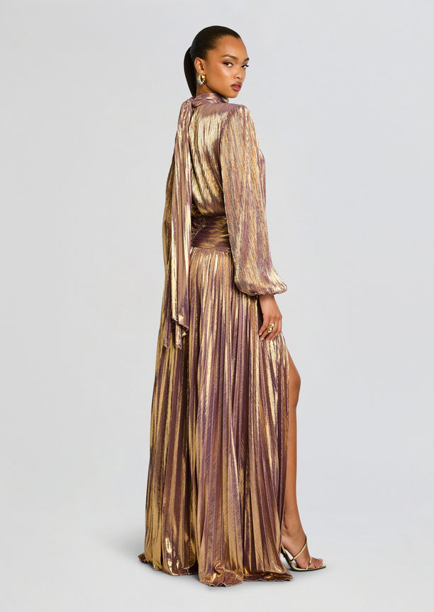 Back and side view of Brienne Dress featuring metallic pleated fabric long puff sleeves a waist sash and thigh high slit