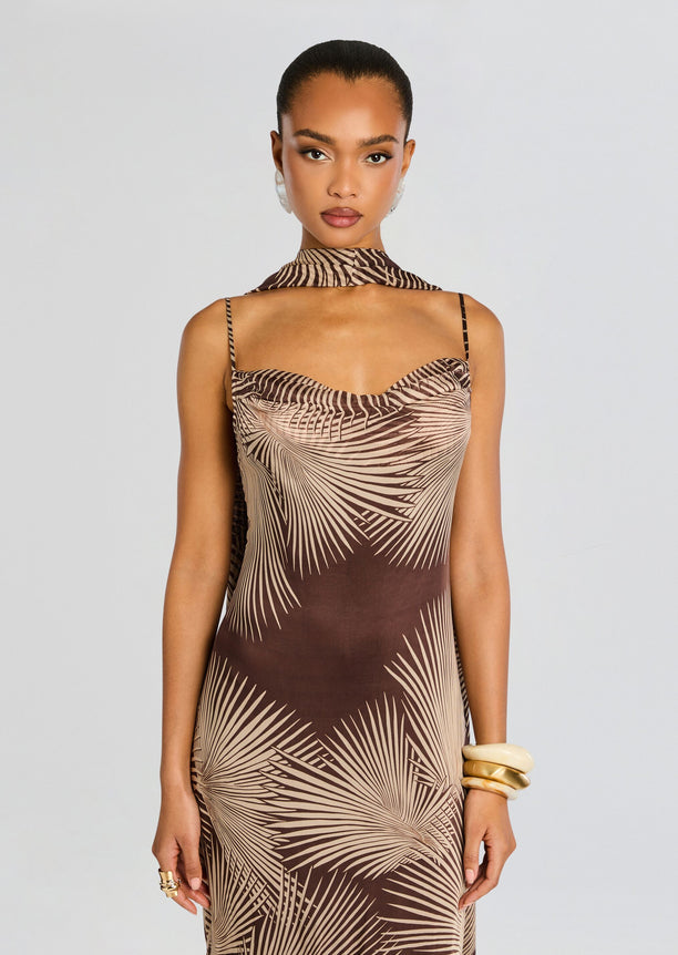 Front view of model in palm leaf print maxi dress with thin straps and a matching neck scarf