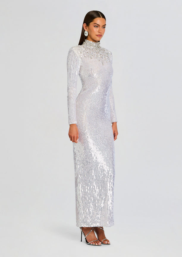 Silver sequined Elisha Embellished Dress on a model in a full length side view with a high neckline and long sleeves.