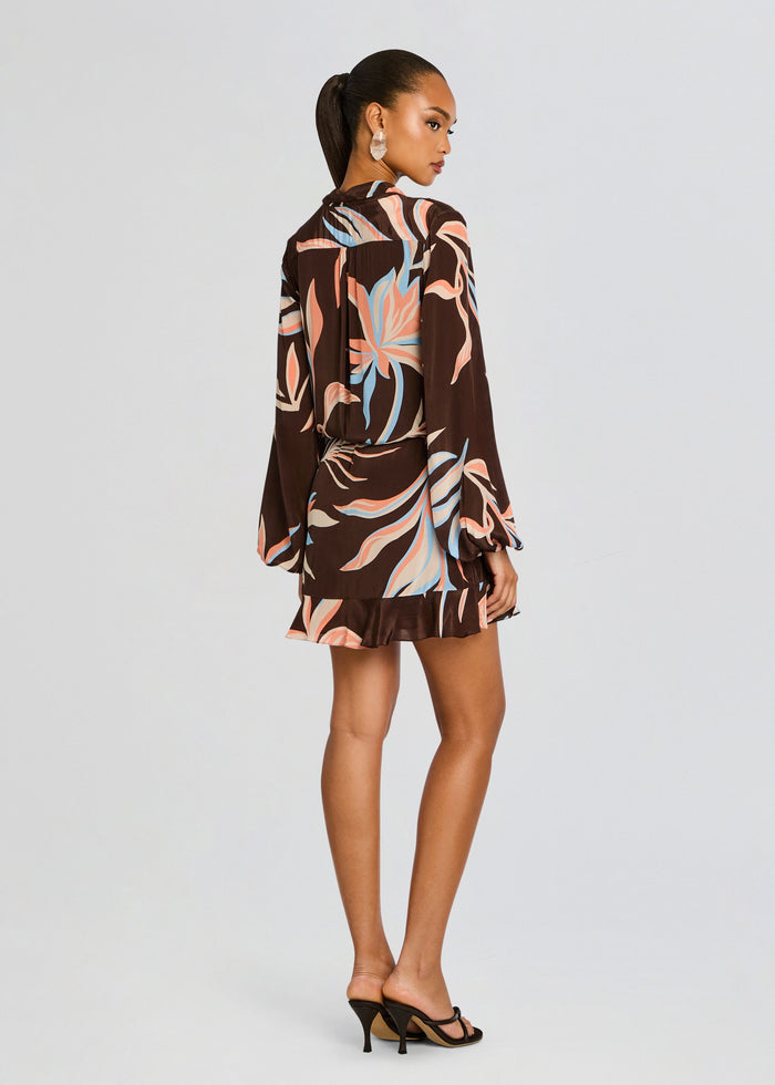 Back view of Fern Front Wrap Mini Dress brown with pastel leaf print, waist tie, and voluminous sleeves. media 4 of 5