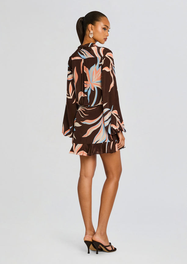 Back view of Fern Front Wrap Mini Dress brown with pastel leaf print, waist tie, and voluminous sleeves.
