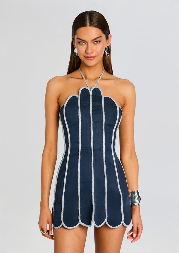Front view of navy blue dress with scalloped white piping and vertical stripe panels