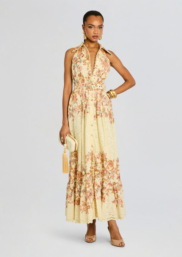 Full-length shot of a model in a cream floral Riah Long Dress with a belted waist and scalloped eyelet hem
