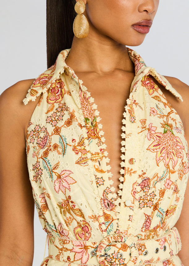 Close-up of the cream floral Riah Long Dress bodice with embroidered flowers and pompom trim along the placket