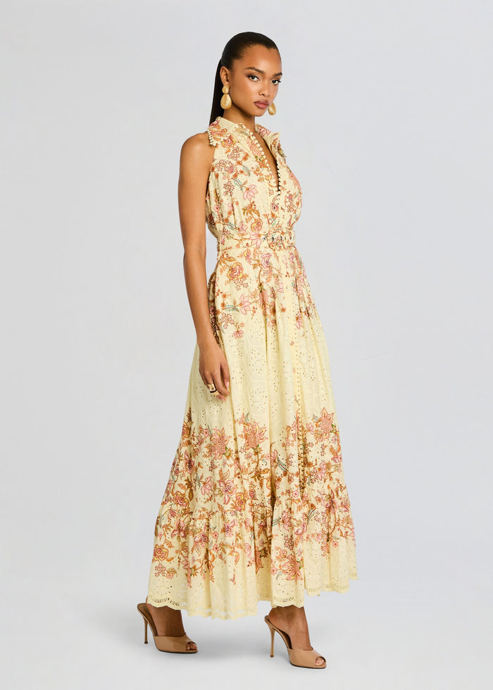 Side view of a model wearing the Riah Long Dress with a belted waist and nude heels media 3 of 5