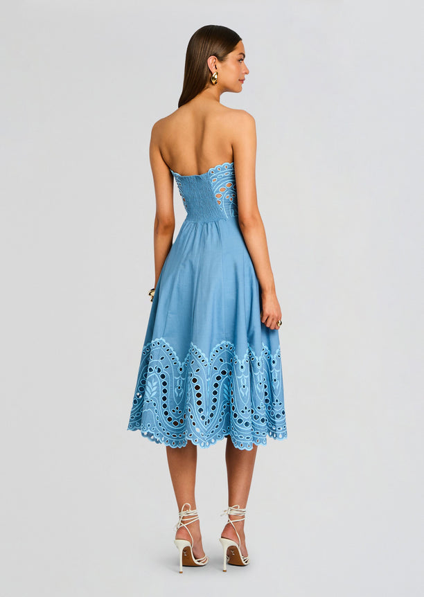 Back view of the blue Marlin Long Dress showing a smocked back and a hem with embroidered scallops.
