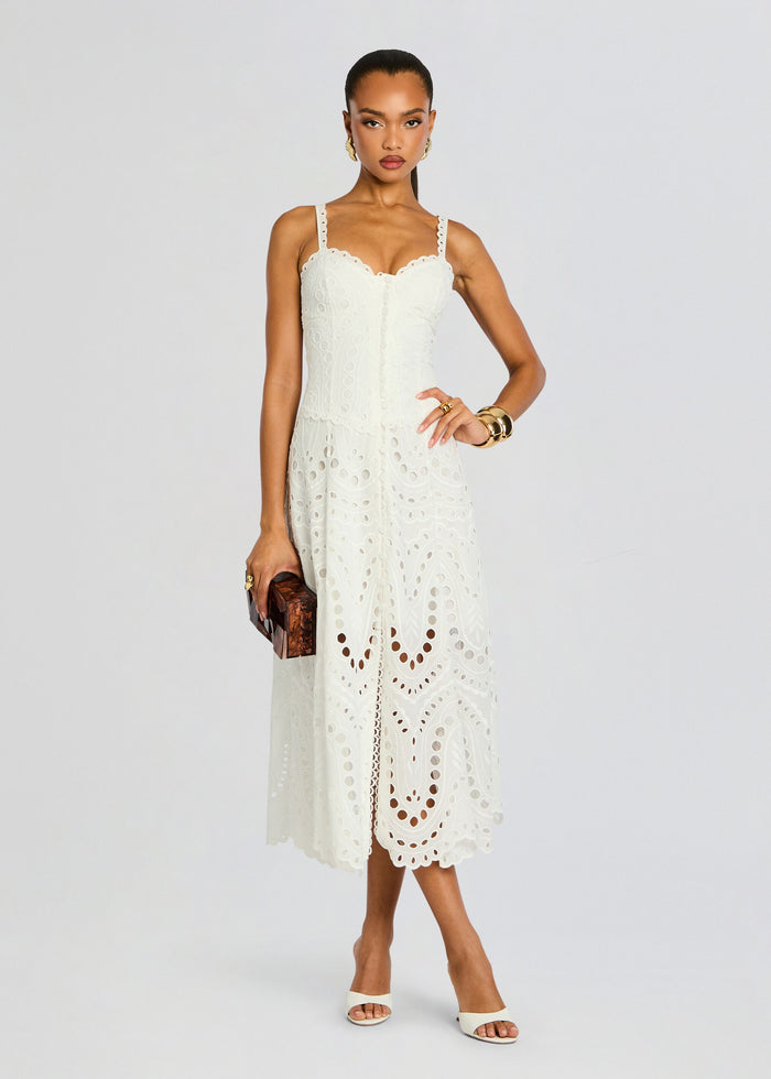 Model in a white Solace Long Dress with scalloped eyelet bodice straps and a full embroidered skirt media 1 of 5