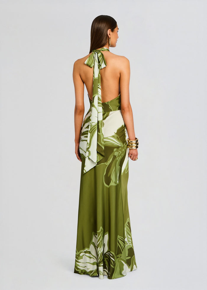 Back view of the Avo Maxi Dress in olive botanical print with a halter neck tie and flowing floor-length skirt. media 4 of 5