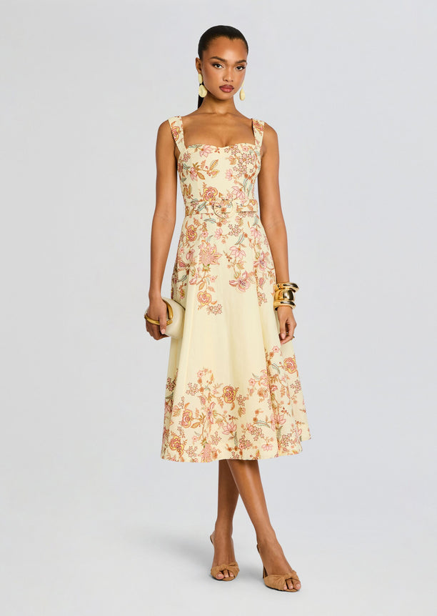 Riah Midi Dress in cream floral print with a matching belt on a model