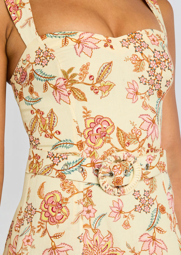 Close up of the Riah Midi Dress bodice showing pastel floral print and a round belt buckle