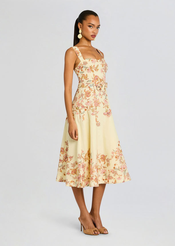 Riah Midi Dress pale yellow with pink floral print, square neckline and belted waist on a model