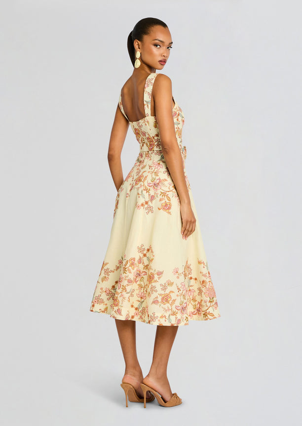Back view of pale yellow Riah Midi Dress with floral print and belted waist
