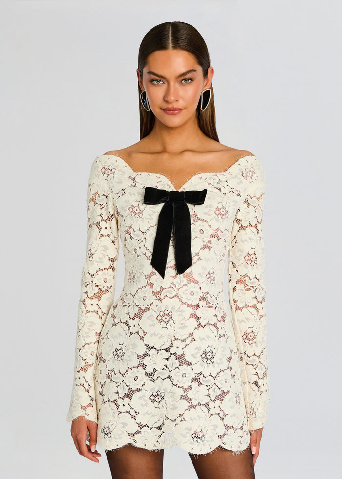 Front view of ivory floral lace mini dress with off the shoulder neckline and black satin bow at the bust media 5 of 5