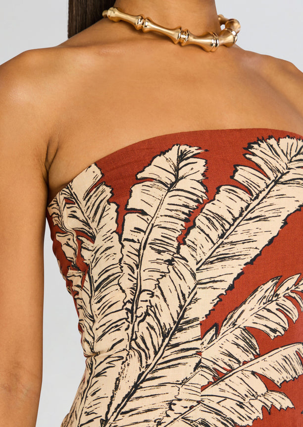 Close up of palm leaf print fabric on the rust strapless Palm Mini Dress