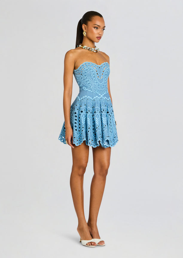 Side view of Bail Short Dress on a model featuring a strapless neckline and scalloped hem