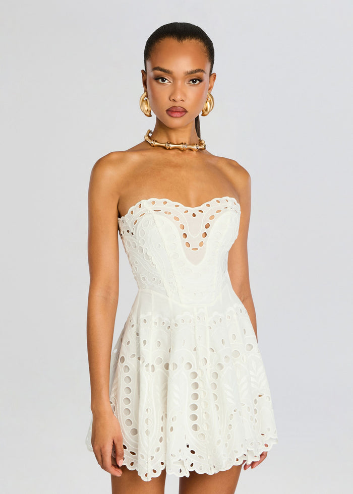White Bail Short Dress strapless with eyelet cutouts and scalloped edges on a model. media 5 of 5