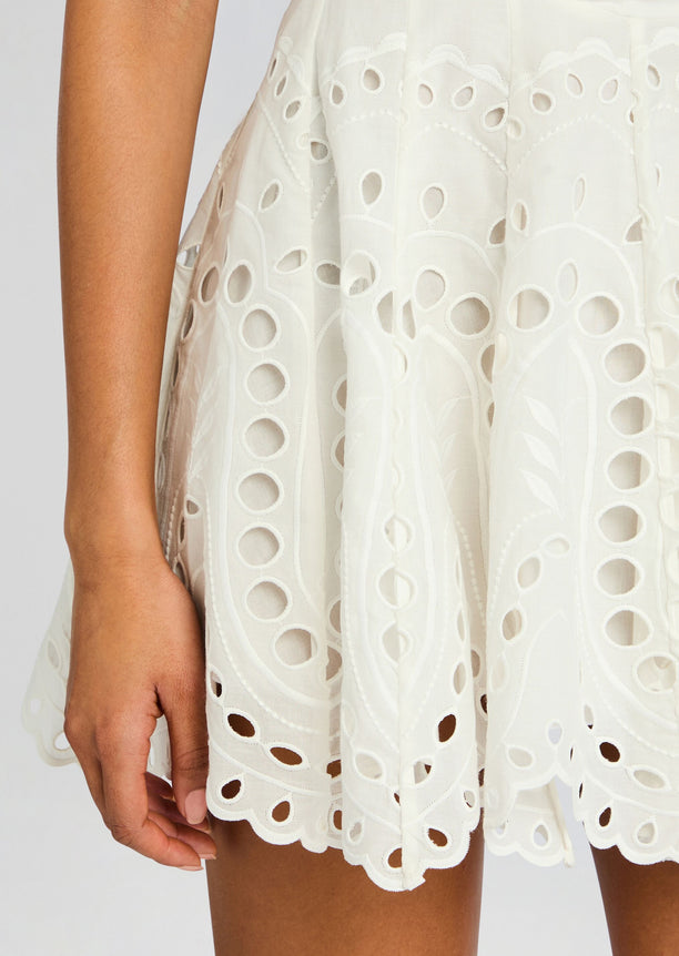 Close up of Bail Short Dress fabric showing white eyelet embroidery and scalloped edges.