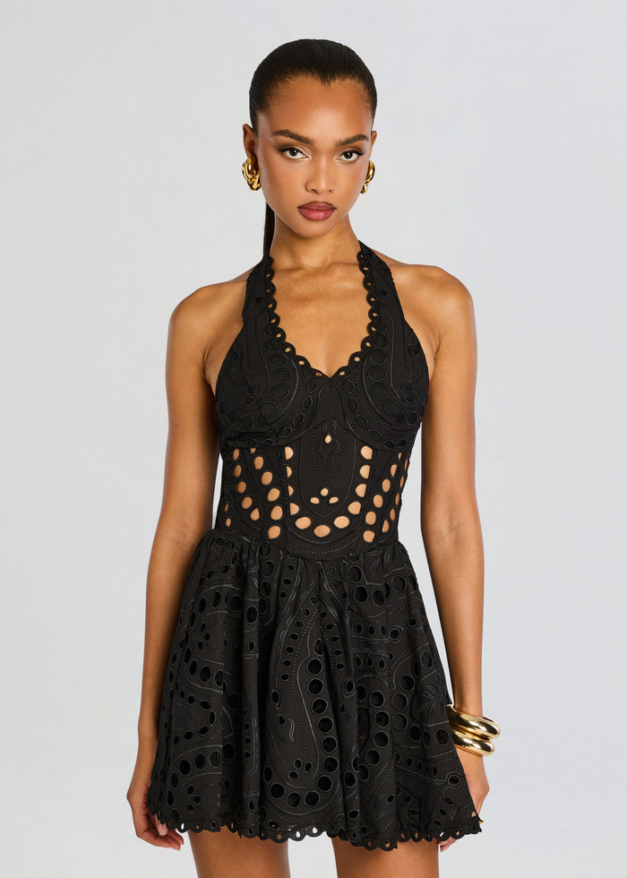 Model wearing a black Sandlight Short Dress with circular cutouts and a halter neckline. media 5 of 5