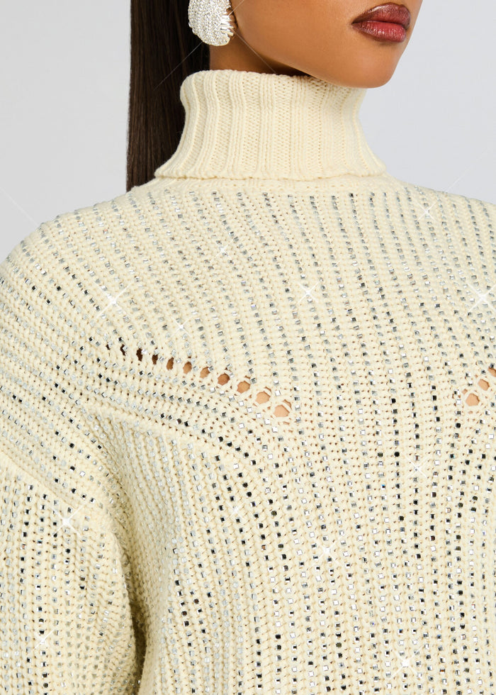 Close-up of the cream Camden Embellished Sweater highlighting the ribbed turtleneck and sequined knit pattern. media 3 of 5