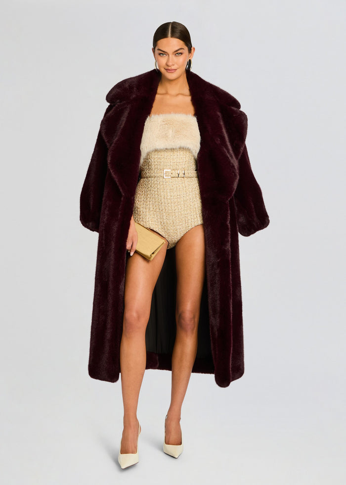 Model wearing burgundy faux fur coat over beige fuzzy top and tweed high-waisted shorts with belt and clutch media 6 of 6