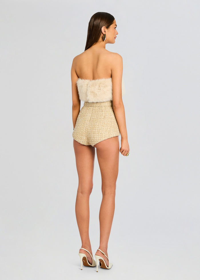 Back view of the Concetta Tweed Romper showing a cream fur bandeau and high waisted tweed shorts with a belt. media 4 of 6