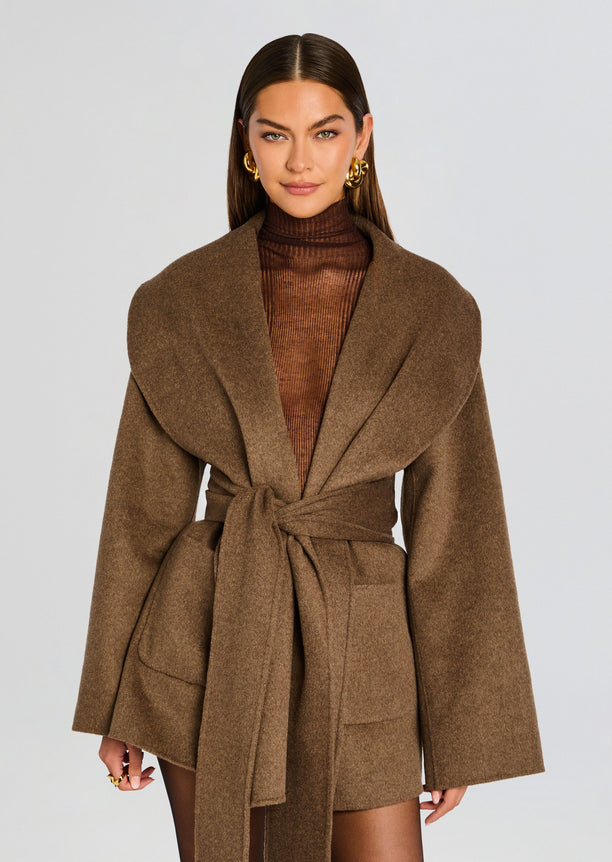 Front view of a model in a camel Dulcetta Wool Coat with wrap silhouette, wide sleeves and a self tied belt.