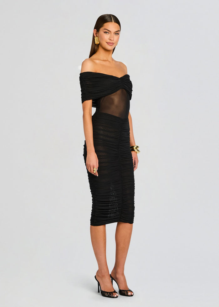 Front view of a model wearing a black off shoulder Auralee Mesh Midi Skirt with a sheer central panel and ruched detailing media 4 of 5