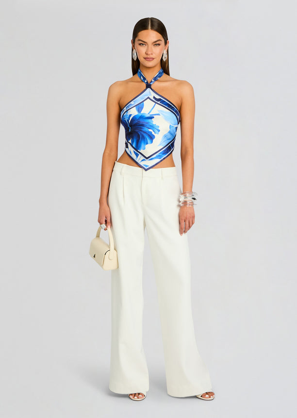 Jamie Silk Top blue floral halter crop top worn with ivory wide-leg trousers and a cream handbag