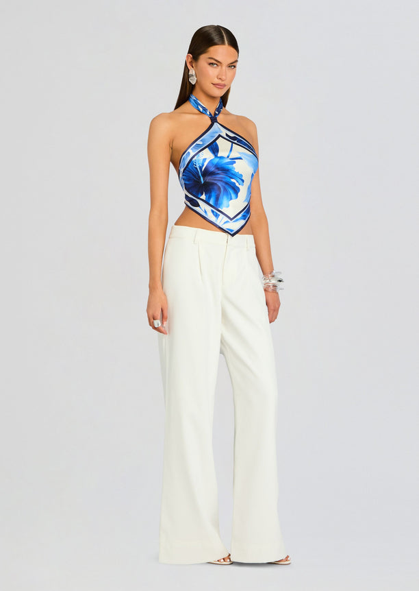 Model wearing Jamie Silk Top with blue floral print paired with ivory wide-leg trousers