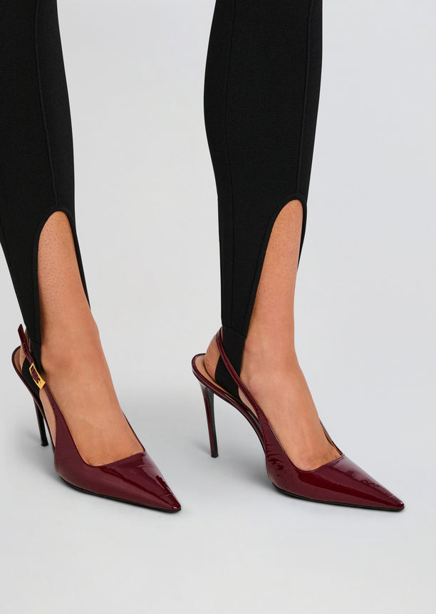 Close up of legs in black Kelsey Stirrup Leggings with burgundy slingback heels