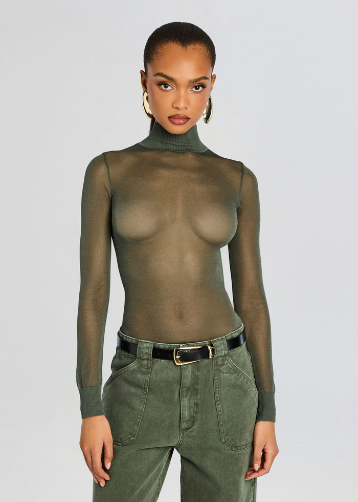 Model wearing Lainey Top a sheer olive green turtleneck with a fitted silhouette and gold hoop earrings media 1 of 6