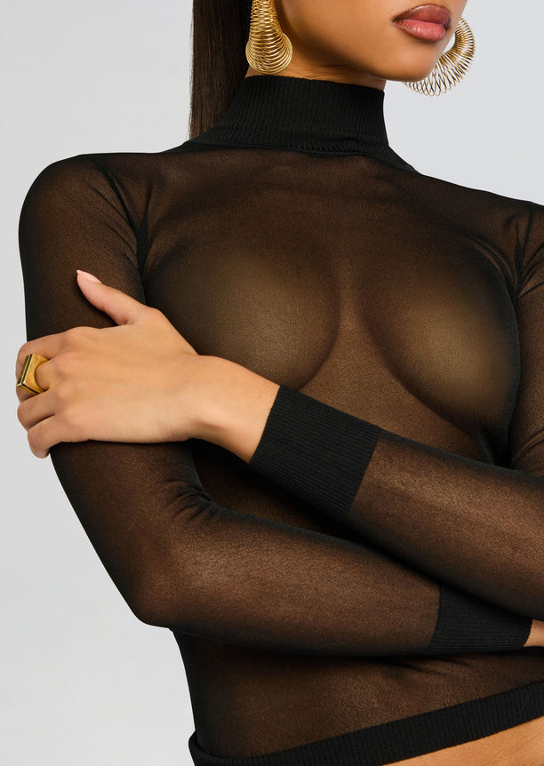Lainey Top close-up on a model wearing a sheer black turtleneck with long sleeves