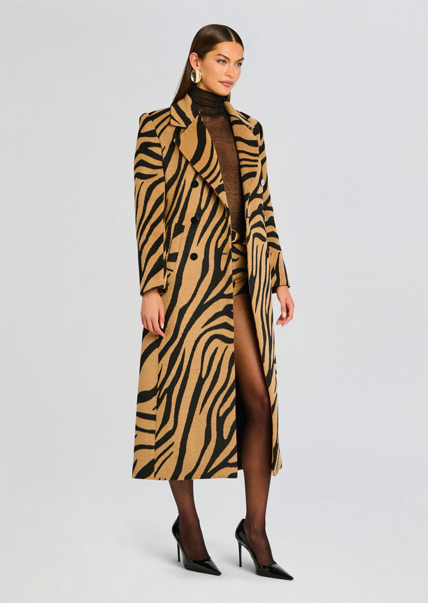 Long camel and black tiger stripe Petal Coat worn by a model in a brown turtleneck and black heels.