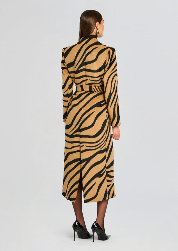 Back view of a full length camel and black tiger stripe Petal Coat tied at the waist.