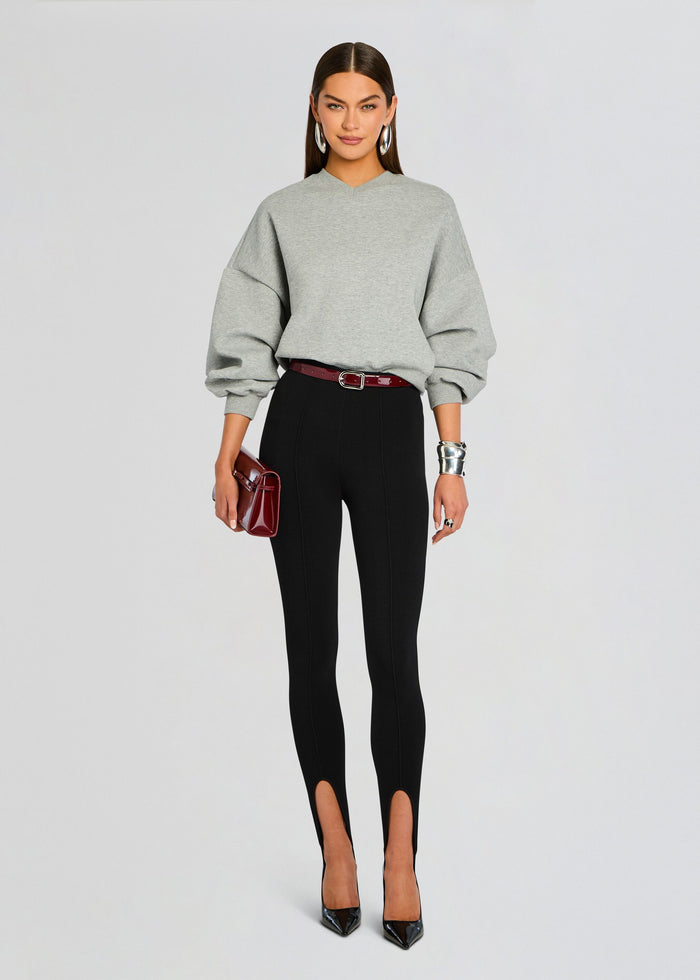 Front view of grey Taley Sweatshirt cinched at the waist with black high-waisted pants and burgundy belt media 5 of 5