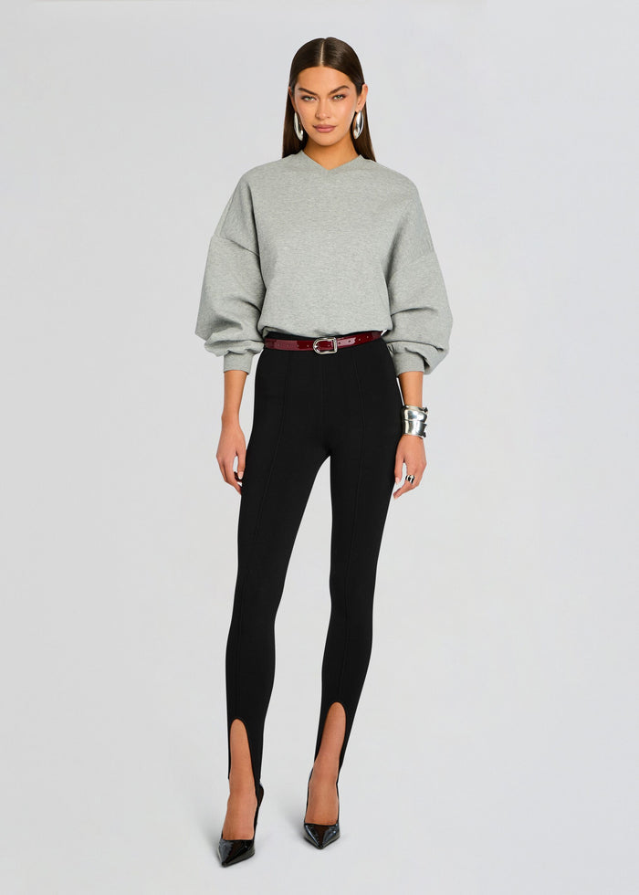 Full length of a model in light gray Taley Sweatshirt paired with black high waisted pants and a burgundy belt media 2 of 5